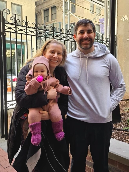 Photo of family with baby outside church