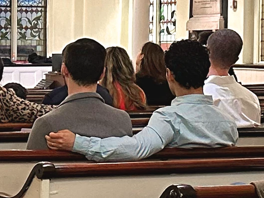 Photo of an LGBT couple in church