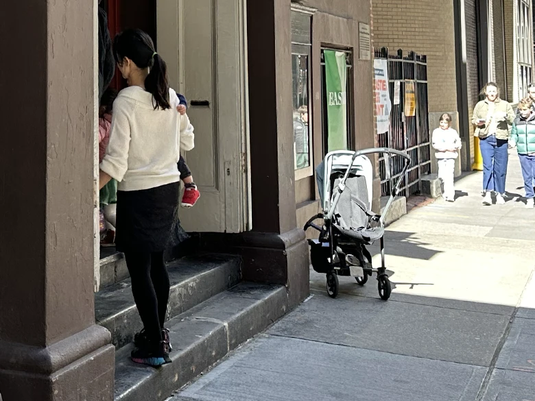 Photo of woman entering church with baby