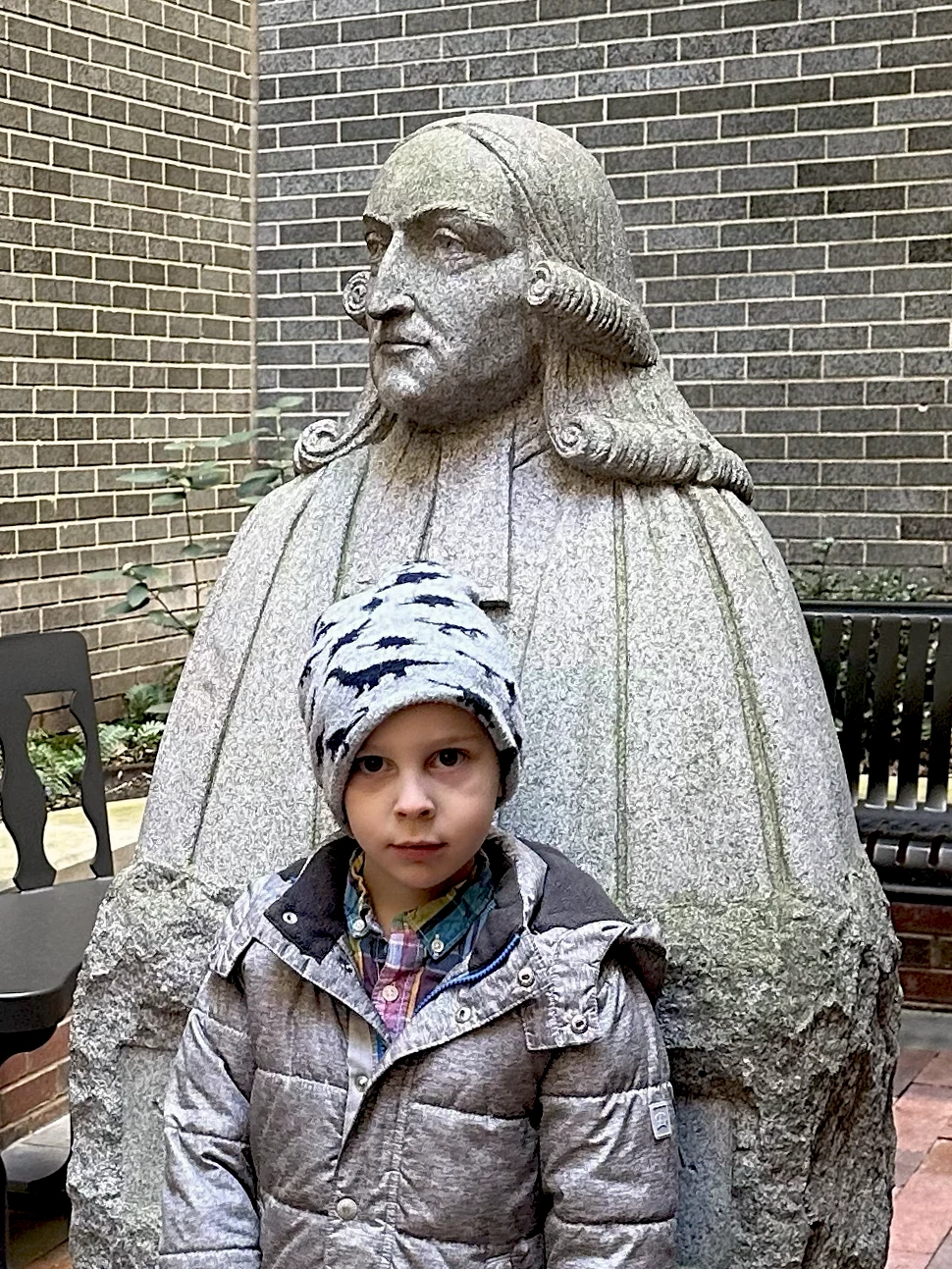 Photo of child with statue of John Wesley